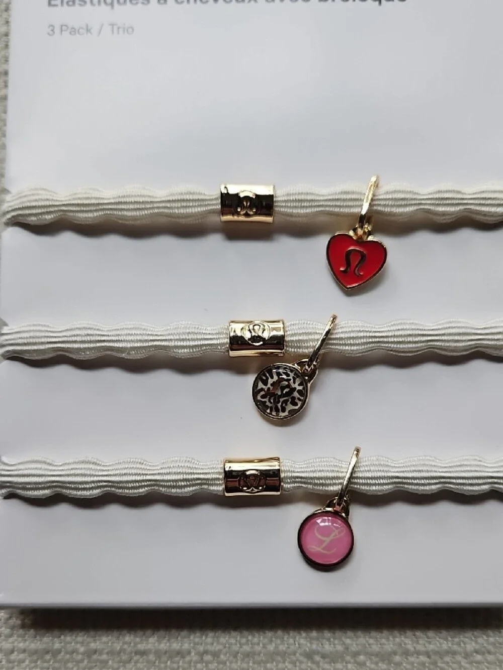 lululemon athletica Charm Hair Ties Trio — White Bands with Red & Pink Charms